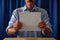 Voter Holding Up a Blank Ballot, Hand Holding Paper, Mustache Man Wearing Blue Shirt During a Political Election Campaign