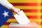 Voter Holds Envelope In Hand Above Vote Ballot. National Catalonia Flag background. Democracy Concept