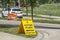 A Voting Place Elections Alberta sign on a busy street. Yellow double sided floor stand