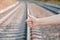 Voting on railway road. Close up female hand with hitch-hiking gesture.