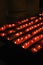 Votive candles on rack in church