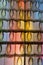 Votive candles with Virgin Mary in a Catholic Church in France, with colorful reflections from a stained glass window