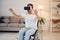 In VR glasses. Disabled man in wheelchair is at home