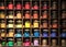 Vrious colorful dye in glass containers ion shelves in a paint shop