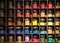 Vrious colorful dye in glass containers ion shelves in a paint shop