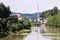 Vsetin, Czech republic - June 02, 2018: Bridge over Vsetinska Becva river between trees and old houses in sunny day
