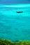 VThe sea looks out to emerald blue. There is 1 floating boat quietly on the waves in the Andaman Sea. At Sunset Beach, Koh Lipe, S