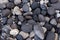 Vulcanic dark round stones at the shore of Ischia, Italy