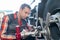 vulcanizing shop worker removing vehicles wheel