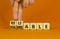 Vulnerable or reliable symbol. Businessman turns wooden cubes and changes the word Vulnerable to Reliable. Beautiful orange