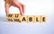 Vulnerable or reliable symbol. Businessman turns wooden cubes and changes the word Vulnerable to Reliable. Beautiful white