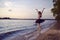 Vulnerable And Sensual Japanese Ballet Dancer in Black Tutu Posing Near Seashore During Ballet Pas in Summertime in Dance Pose