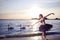 Vulnerable And Sensual Japanese Ballet Dancer in Black Tutu And Silver Crown Posing Near Seashore During Ballet Pas in Summertime