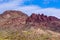 Vulture peak in Arizona. Saguaro cactus near the base; blue sky and clouds overhead