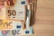 wad of cash on a wooden background, euro cash, corruption, economy, banking,news