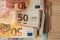 wad of cash on a wooden background, euro cash, corruption, economy, banking,news