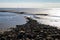 The Wadden Sea on the North Sea with stone fortifications, tideways and measuring points and a view up to the horizon