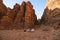 Wadi-Rum desert Jordan 17-09-2017 Four Bedouin men sit in the middle of the desert on a stone or crouch, between the high mountain