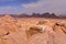 WADI RUM, JORDAN: A Jordanian man overlooking the Wadi Rum desert from the top of a mountain