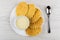 Wafer cookies, bowl with condensed milk in white plate, teaspoon