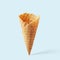 Wafer ice cream cone on a blue background. Minimalistic concept