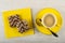 Wafers with chocolate and peanut on paper napkin, cup of coffee , spoon on saucer on wooden table. Top view