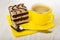 Wafers with chocolate and peanut, spoon, cup of coffee on napkin on wooden table