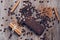 Wafers in chocolate on a wooden table with coffee beans and cocoa powder. View from above.