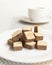Wafers cubes with chocolate. on White plate