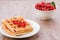 wafers with red berries in a white plate/wafers with red berries in a white plate. Selective focus