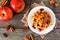 Waffle with baked autumn apples, pecans and caramel, above view table scene over a rustic wood background