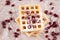 Waffle on brown paper with pomegranate seed