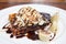 Waffle with chocolate sauce almonds closeup