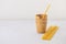 Waffle coffee cups and pasta straws on neutral background with copy space