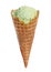 Waffle cone with sweet pistachio ice cream on white