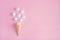 waffle cone and white twisted meringues on pink background