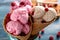 Waffle cones with tasty raspberry ice-cream on blurred background, closeup