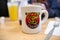 Waffle House logo coffee cup inside the breakfast restaurant. Focus only on the logo on the