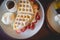Waffle pancake desert with vanilla ice cream, fresh strawberry and honey syrup