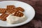 Waffle pretzels with cream cheese on a plate