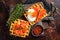 Waffle Sandwich with cream cheese, smoked salmon, egg and red caviar. Dark background. Top view