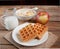 Waffles with banana, muesli, apple and milk jug