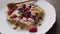 waffles with berries and honey rotated.4K video.