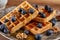 Waffles with blueberries, walnuts and maple syrup