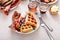 Waffles for breakfast with bacon and berries, breakfast table with variety of food