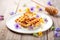 waffles with edible flowers and honeycomb, elegant plating