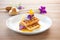 waffles with edible flowers and honeycomb, elegant plating