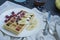 Waffles with fresh banana, raspberries, blueberries for breakfast. Belgian waffles. Dark wooden background