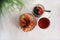 Waffles with jam on a white saucer, a Cup of tea on the table and a glass vase with a pine branch