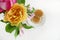 Waffles in a Plate isolated on a White Background and a Vase with Pink and Yelow Roses